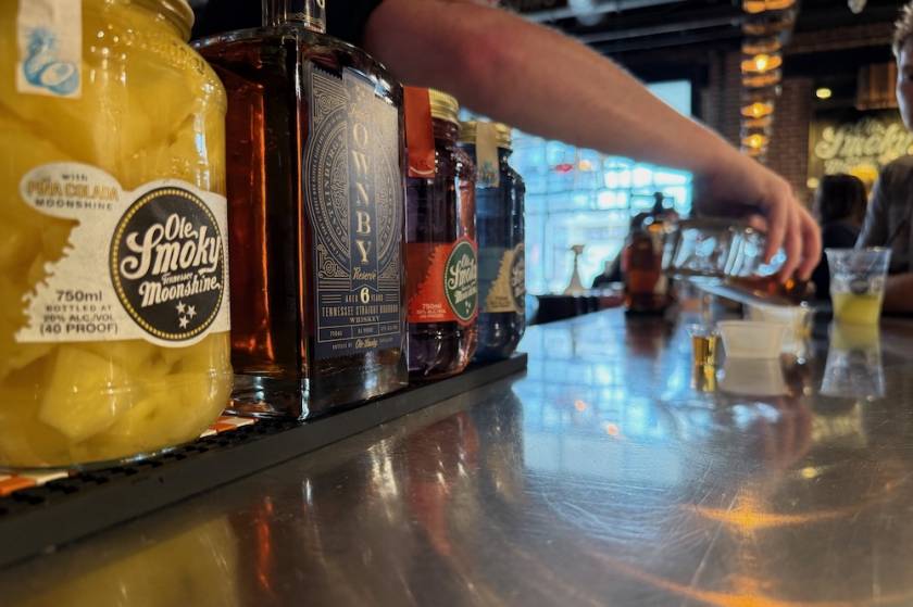 person pouring tasting samples at Ole Smoky Distillery